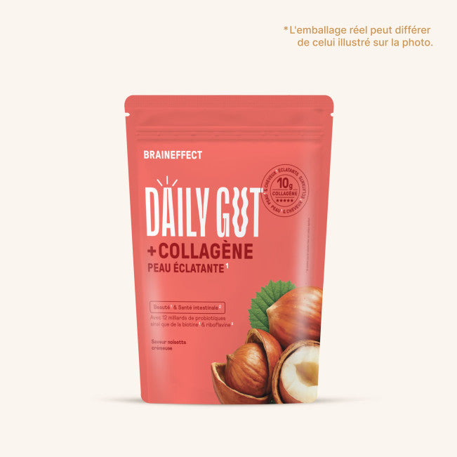 Eine rosafarbene Verpackung von DAILY GUT + Kollagen, umgeben von Haselnüssen und frischen Blättern. Für ganzheitliches Wohlbefinden und harmonische Rituale.