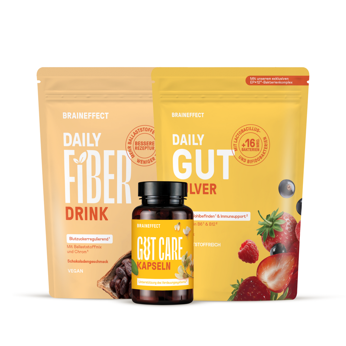 Zwei BRAINEFFECT Beutel mit Aufschriften wie "DAILY FIBER DRINK" und "DAILY GUT" sowie eine Dose "GUT CARE KAPSELN" vor dunklem Hintergrund.