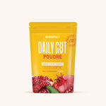 Pochette jaune vif étiquetée 'DAILY GUT POUDE' avec une image de grenade, favorise les rituels de bien-être.