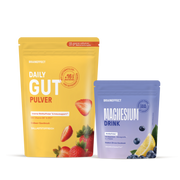 Two BRAINEFFECT pouches on a black background: left is yellow "DAILY GUT PULVER" with strawberries and "Mit unserem exklusiven EPX12-Bakterienkomplex", right is purple "MAGNESIUM DRINK" with blueberries and lemon.